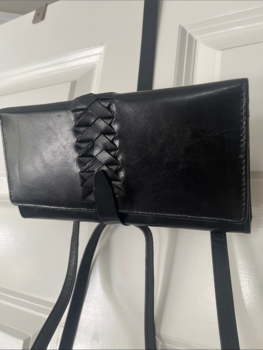 Lodi’s leather crossbody RDIF wallet with leather braid detail